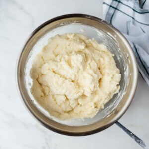 Soft Bisquick dumpling dough in a mixing bowl, ready to be spooned into chicken and dumplings.