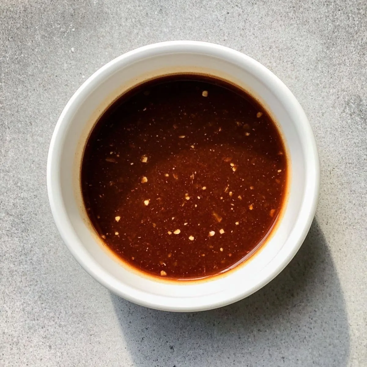 Perfect Longhorn Brussels sprouts signature sauce in white bowl with honey butter mixture and spices, showing the secret copycat recipe sauce