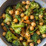 Perfect garlic broccoli stir fry with chickpeas showing crisp-tender broccoli florets, golden chickpeas and glossy sauce coating in close-up detail