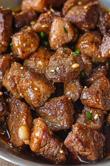 Garlic butter steak bites perfectly seared with golden brown crust and fresh parsley garnish