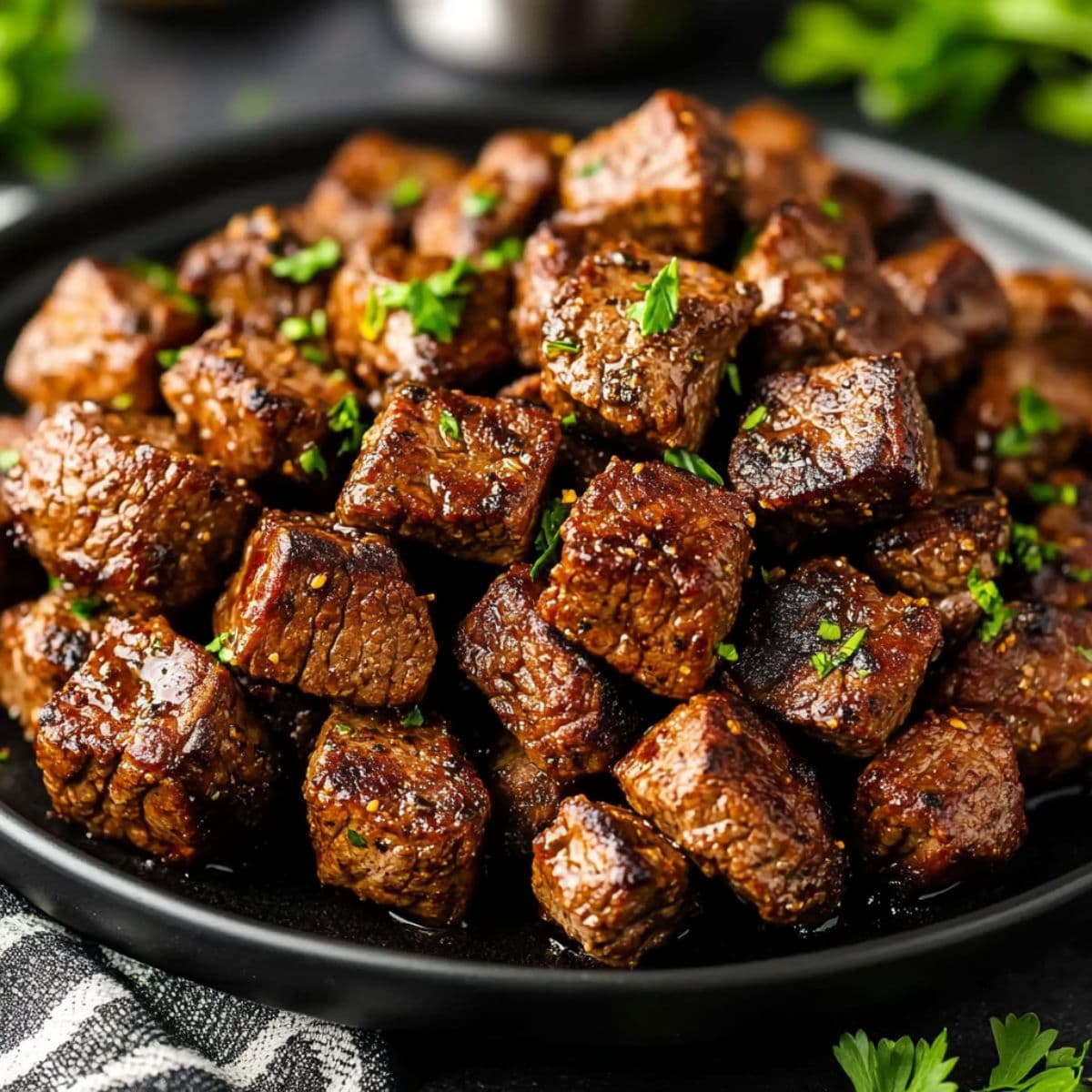 Garlic butter steak bites restaurant style with perfect caramelization and fresh herb garnish
