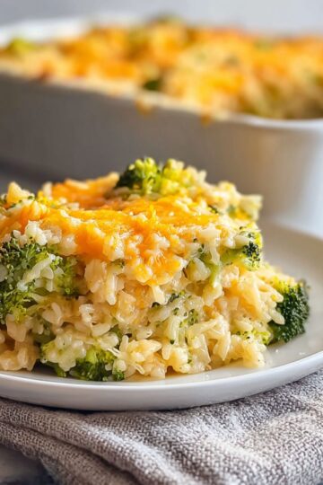 This golden broccoli rice casserole creates the perfect bubbling comfort food with tender rice and vibrant green broccoli. Ready in just 30 minutes with simple pantry ingredients that transform into pure magic! Perfect for family dinners, potluck gatherings, or when you need that cheesy casserole satisfaction. You'll love how this broccoli cheese rice casserole delivers restaurant-quality results with minimal effort. Save this golden comfort food recipe and serve it warm from the oven!