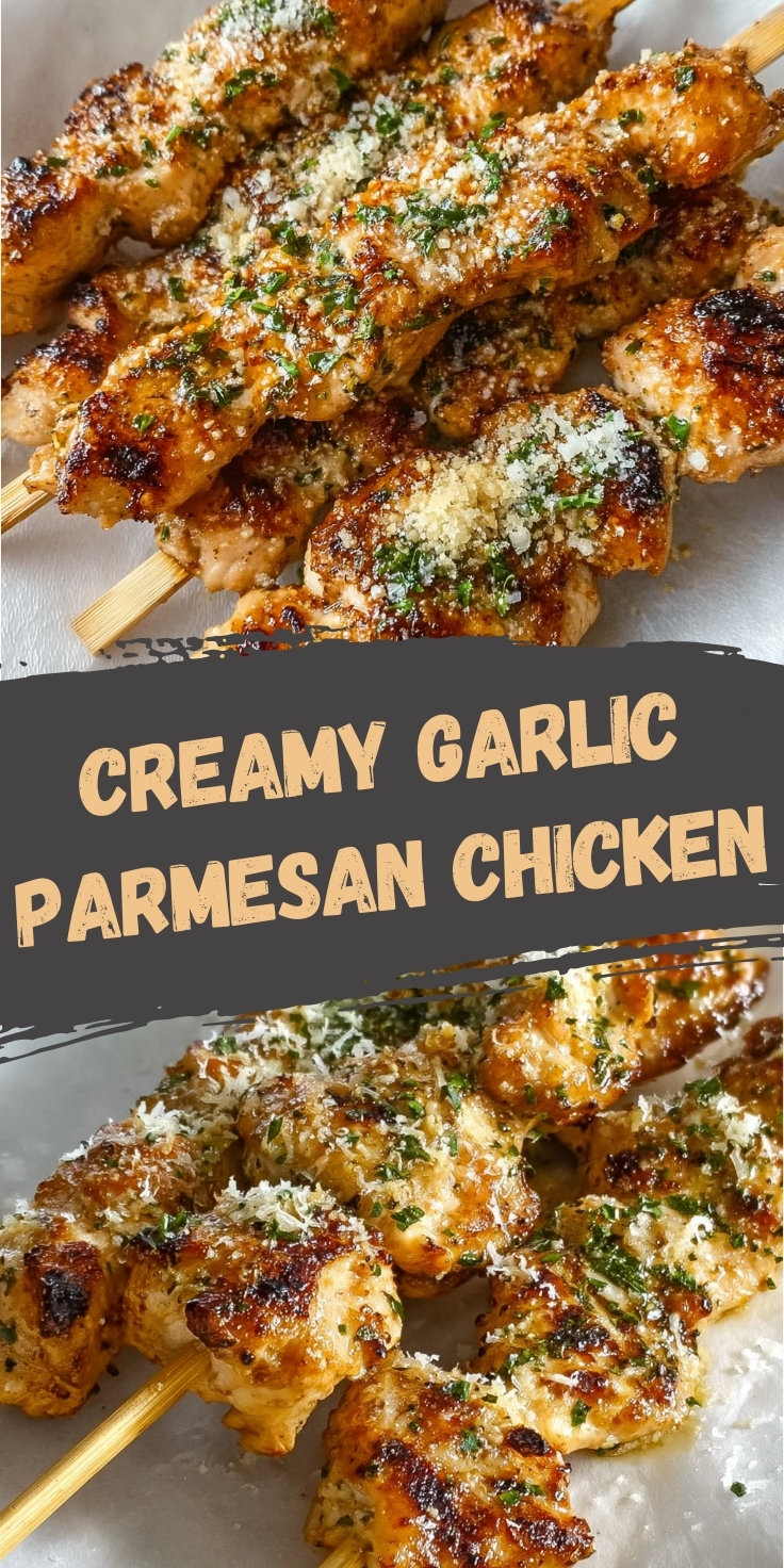 Garlic parmesan chicken skewers with golden brown chicken pieces, melted parmesan cheese, and fresh herbs on wooden sticks