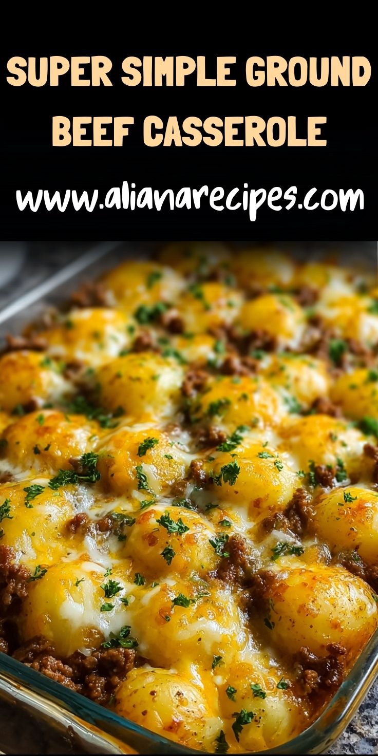 Ground beef casserole with golden melted cheese and tater tots in glass baking dish with fresh herbs