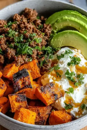Ground beef hot honey bowl with roasted sweet potatoes, avocado, and yogurt.