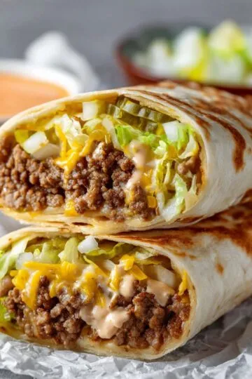 Stacked big mac wraps sliced open to reveal juicy beef and pickles.