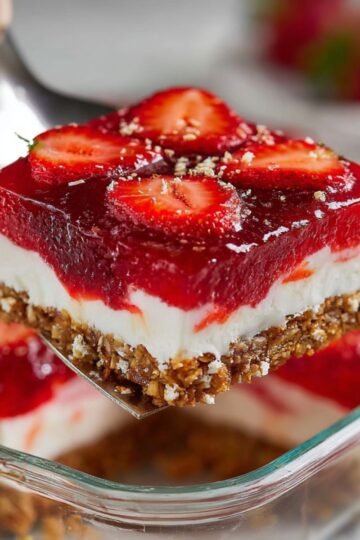 Close up of strawberry pretzel salad recipe showing creamy white filling and red fruit