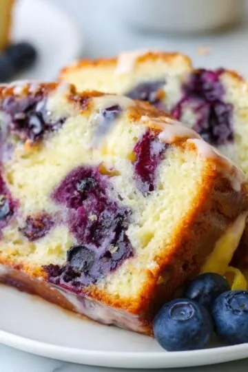 Glazed Blueberry Loaf Bread pieces with visible white icing and bright yellow lemon peel.