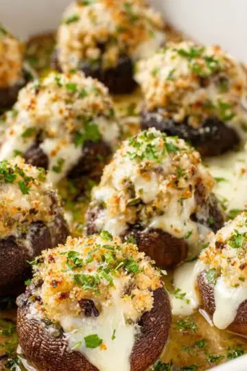 Olive Garden Stuffed Mushrooms 12 White baking dish filled with hot Olive Garden stuffed mushrooms and melted cheese.